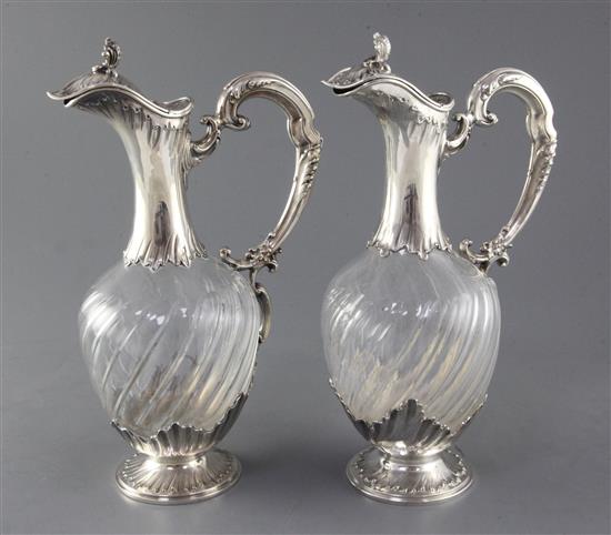 A pair of late 19th/early 20th century French 950 standard silver mounted glass rococco style claret jugs by Henri Sufflot, Paris,